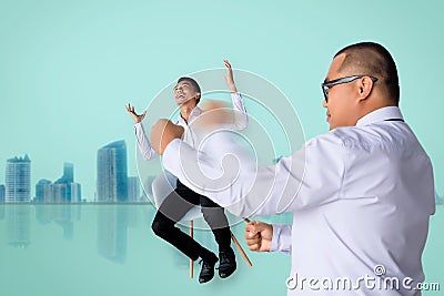 Asian business man punching business man sitting chair Express feeling In room cityÂ blurry background Metaphor for Success financ Stock Photo